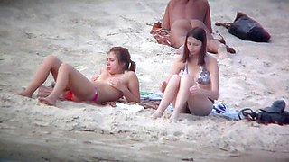 Beach spy captures two friends sunbathing topless