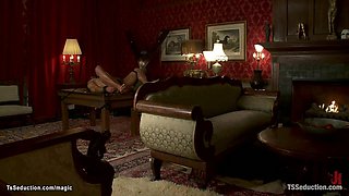 Trans doms give footjob to bound man