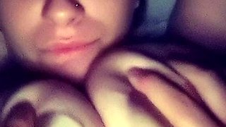 A super sexy brunette massages her big boobs