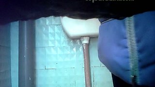 White amateur chick in coat filmed on cam in the toilet