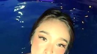 Exotic bombshell performs sensual striptease in the pool