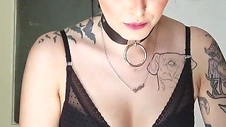 Tattooed gothic lady smoking in the kitchen